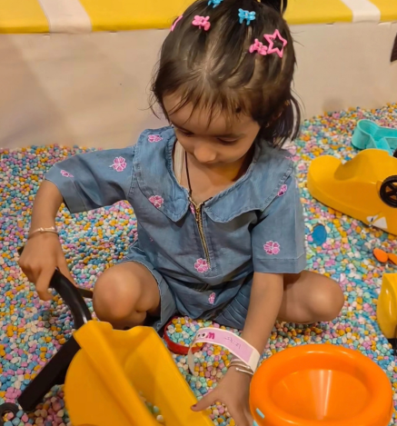 Child enjoying sand pit play at Wooray Dehradun