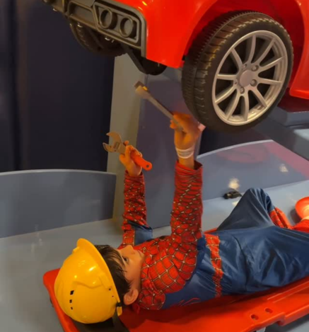 Child pretending to repair a car at Wooray Dehradun