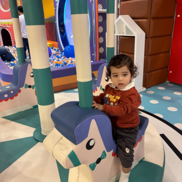 Child enjoying a fun ride at Wooray kids play area