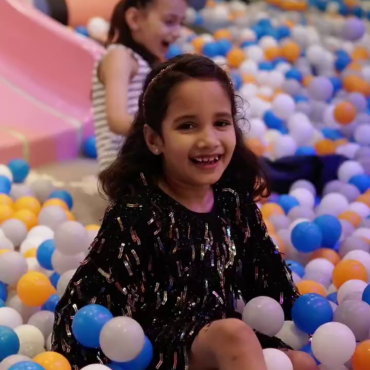 Girl playing happily in the ball pit at Wooray