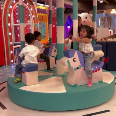 Children enjoying a merry-go-round ride at Wooray