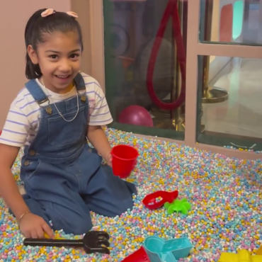 Girl playing with sand toys in the sensory play area