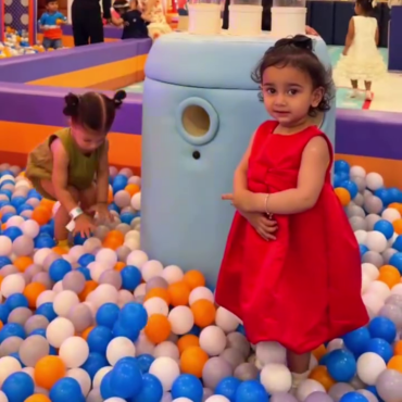 Children playing together in the colourful ball pit
